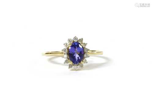 A gold tanzanite and diamond cluster ring,