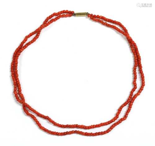 A two row barrel shaped coral bead necklace,