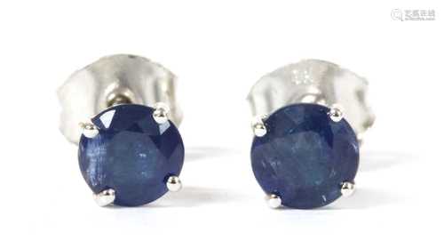 A pair of white gold single stone sapphire stud earrings,