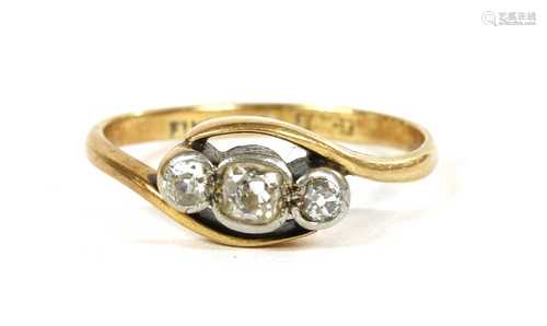 A gold three stone diamond crossover ring,