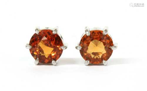 A pair of white gold single stone hessonite garnet earrings,