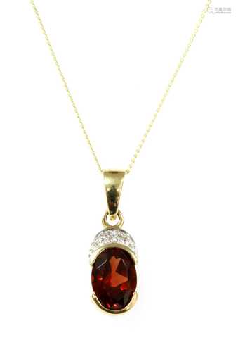 A gold garnet and diamond pendant,