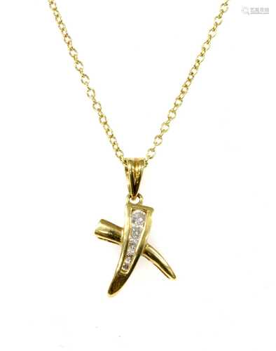 An 18ct gold diamond set 'kiss' style pendant,