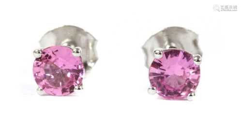 A pair of white gold single stone pink sapphire stud earring...