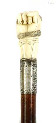 AN IVORY FIST CANE,