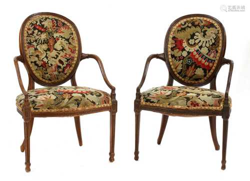 An elegant pair of Hepplewhite Revival elbow chairs,