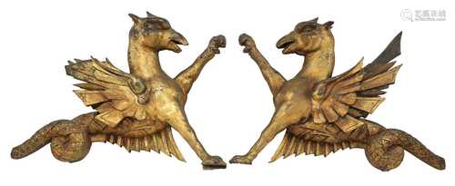 An opposing pair of carved giltwood dragon finials,