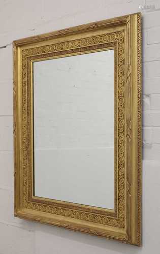 A modern carved giltwood wall mirror,