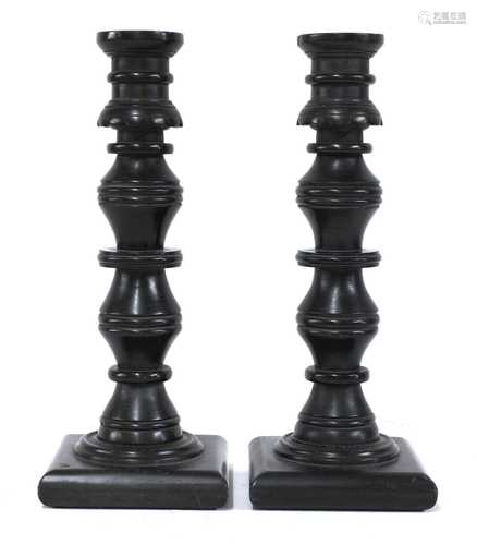 A pair of coal candlesticks,