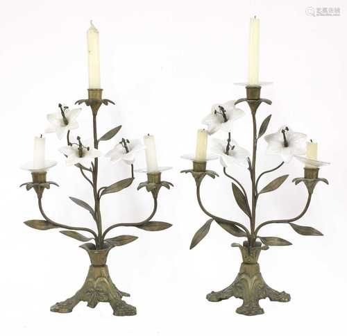 A pair of opaline glass and gilt metal three-light candelabr...