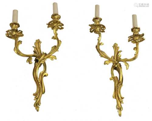 A pair of French rococo-style gilt-bronze wall lights,