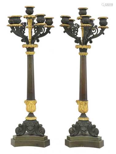 A pair of French Empire bronze and parcel gilt candelabrum,