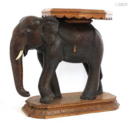 An Indian sandalwood occasional table in the form of an elep...