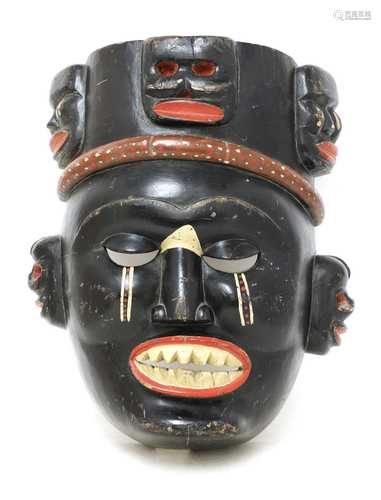 A large carved wood tribal mask,