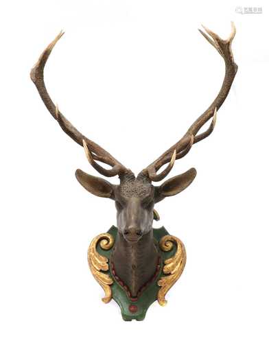 A carved and polychrome painted wooden stag head,