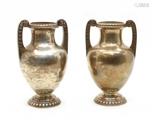 A pair silver twin-handled urns,