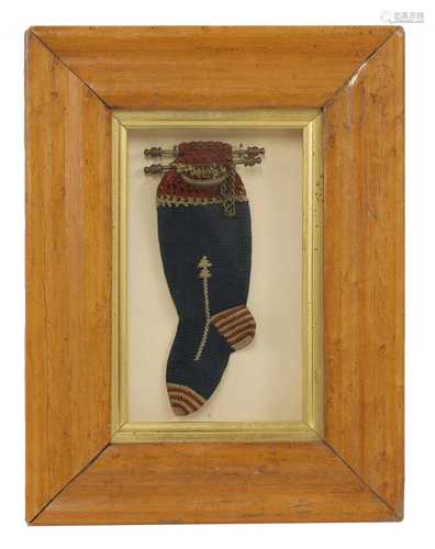 A woven coin purse in the form of a miniature stocking,