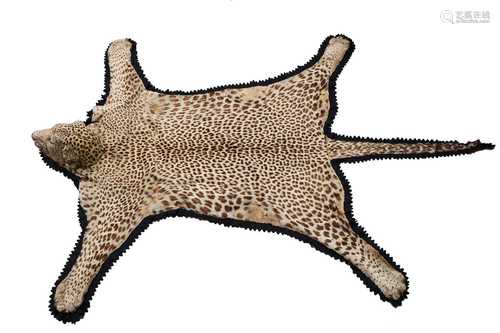 A taxidermy African leopard-skin rug,