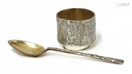 A silver egg cup and spoon set