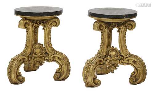 A pair of ornately carved giltwood stands