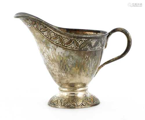 An Arts and Crafts silver cream jug