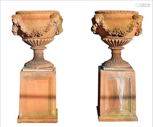 A pair of terracotta garden urns,