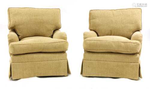 A pair of easy armchairs,