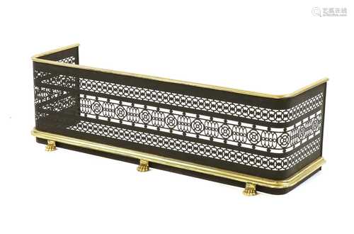 A brass and ebonised fender,