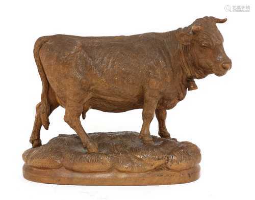 A Black Forest carved wooden model of a cow,