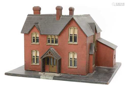 A wooden model of a red brick villa