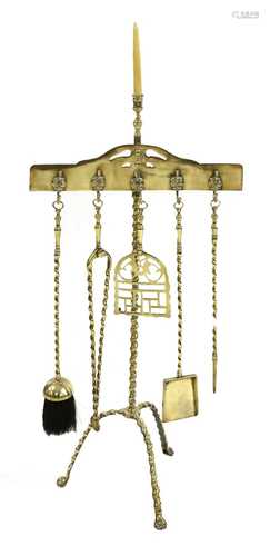 A set of five twisted brass fire tools on stand,