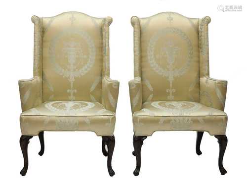 A pair of wingback armchairs,