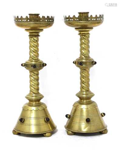 A pair of brass ecclesiastical candlesticks