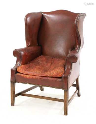 A George III-style red leather wingback armchair,