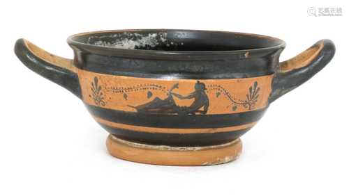 A Greek black glazed figure kylix,