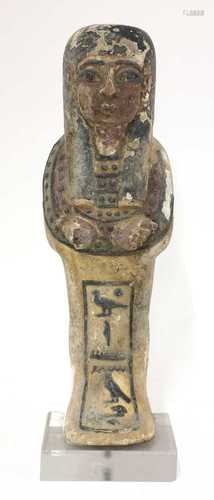 An Egyptian carved and polychrome painted wooden shabti figu...