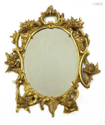 A carved giltwood rococo-style oval mirror,