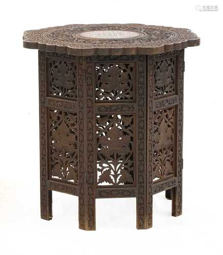 A folding carved hardwood Indian table,