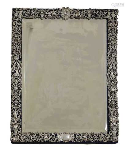 A large silver-framed easel mirror,