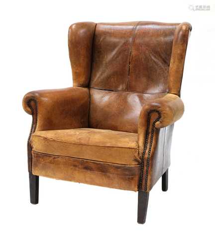 A George III-style leather wingback armchair,