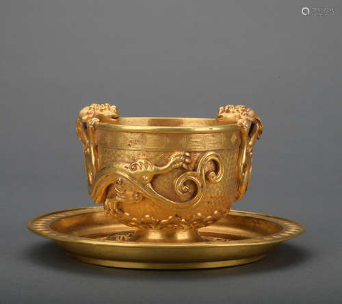 A gold winecup and holder