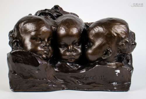 A patinated plasted sculpture of 3 children heads