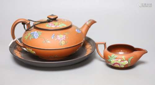 A Wedgwood enamelled terracotta teapot, milk jug and a basal...