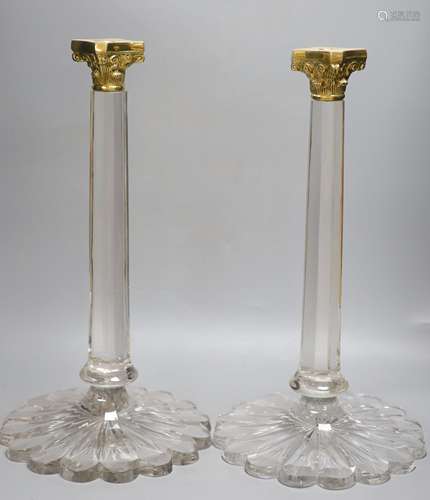 A pair of large glass corinthian column candlesticks, with g...