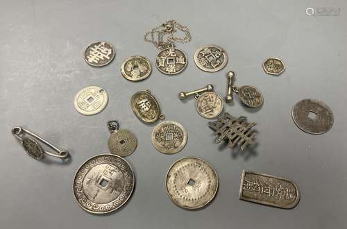 China, a group of silver and white metal coin charms, brooch...