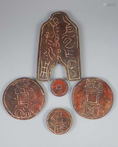 A group of five Chinese stone models of archaic coins from W...