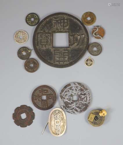 A group of Japanese bronze coin charms or amulets, 19th/20th...