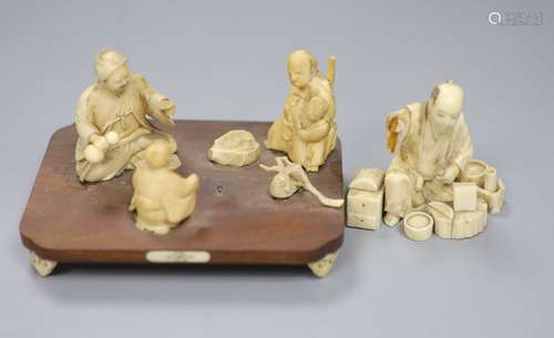 A Meiji period Japanese ivory okimono figural group, raised ...