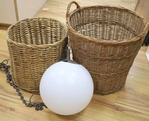 A glass hanging lamp and two wicker baskets