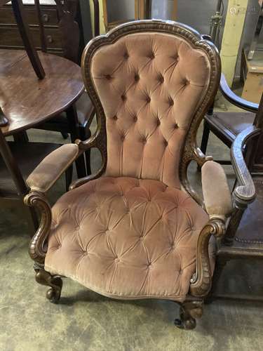 A Victorian carved walnut upholstered spoon back armchair, w...